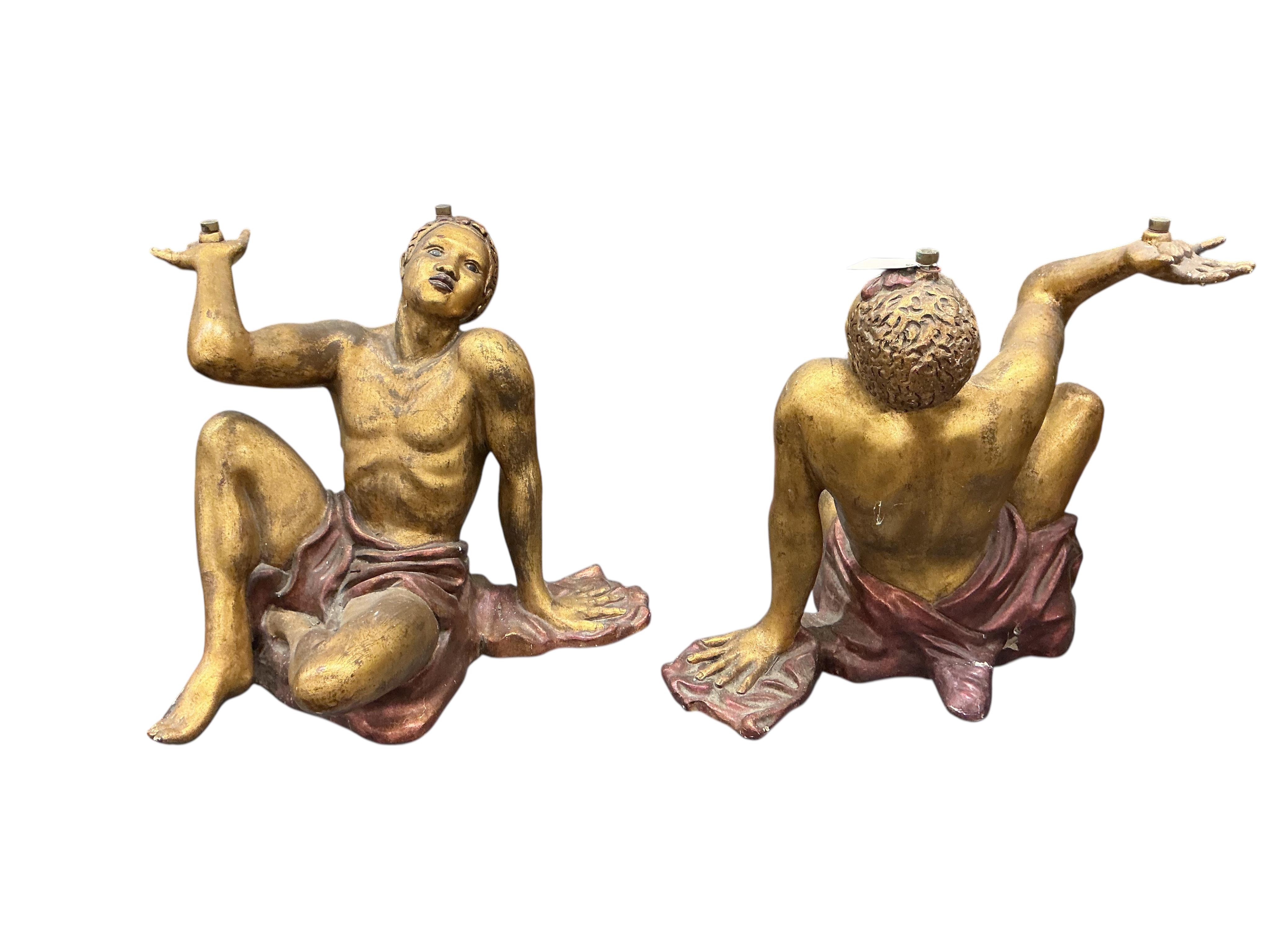 A pair of Venetian style painted carved wood seated Blackamoor figural table supports, height 54cm